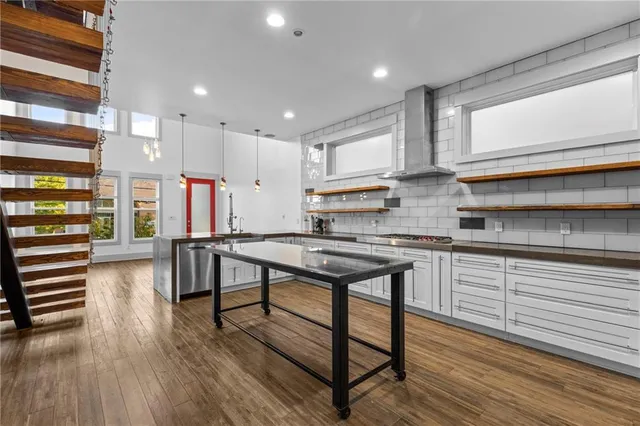 a kitchen with stainless steel appliances granite countertop a stove and a refrigerator