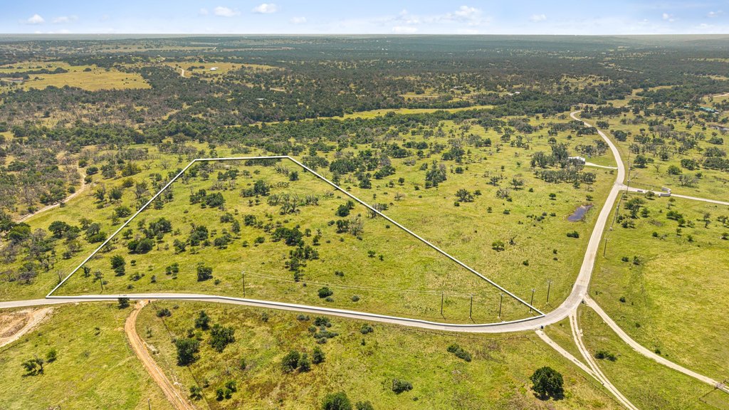 A verdant, open lot with natural foliage offers an ideal rural setting.