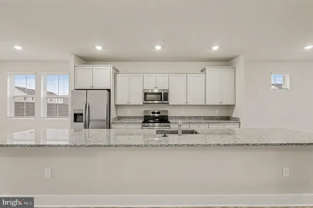a kitchen with stainless steel appliances granite countertop a sink and a granite counter tops