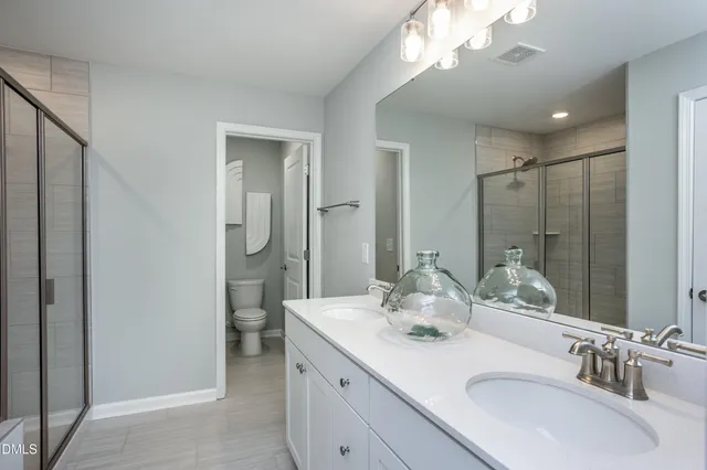 a bathroom with a double vanity sink mirror and double