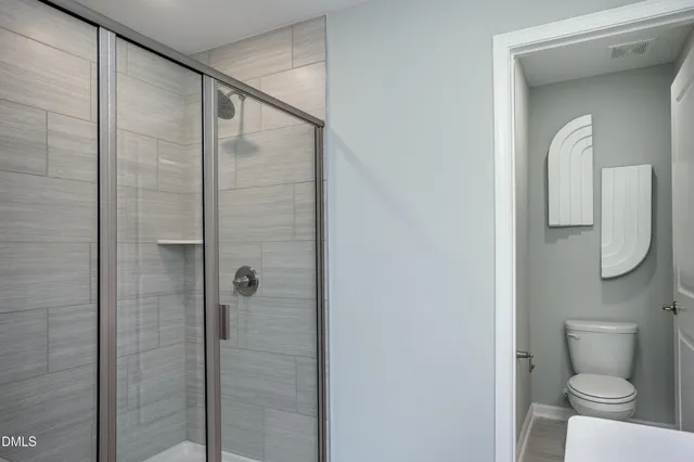 a bathroom with a shower and toilet