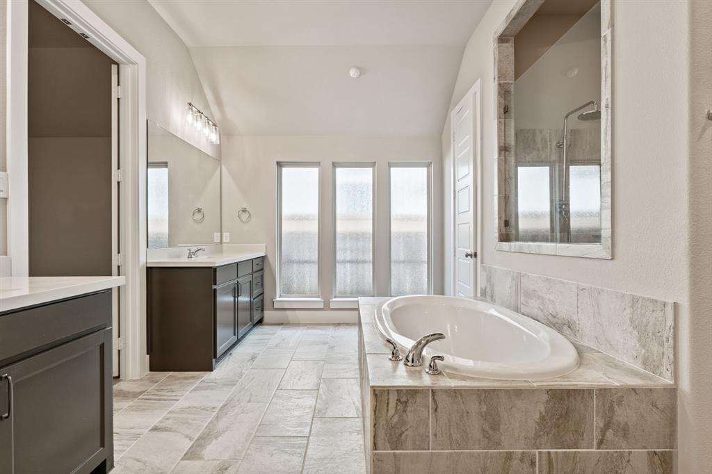 1314 Buttermere Street Forney, TX 75126 - Photo 13 of 32 a spacious bathroom with a tub a sink and mirror