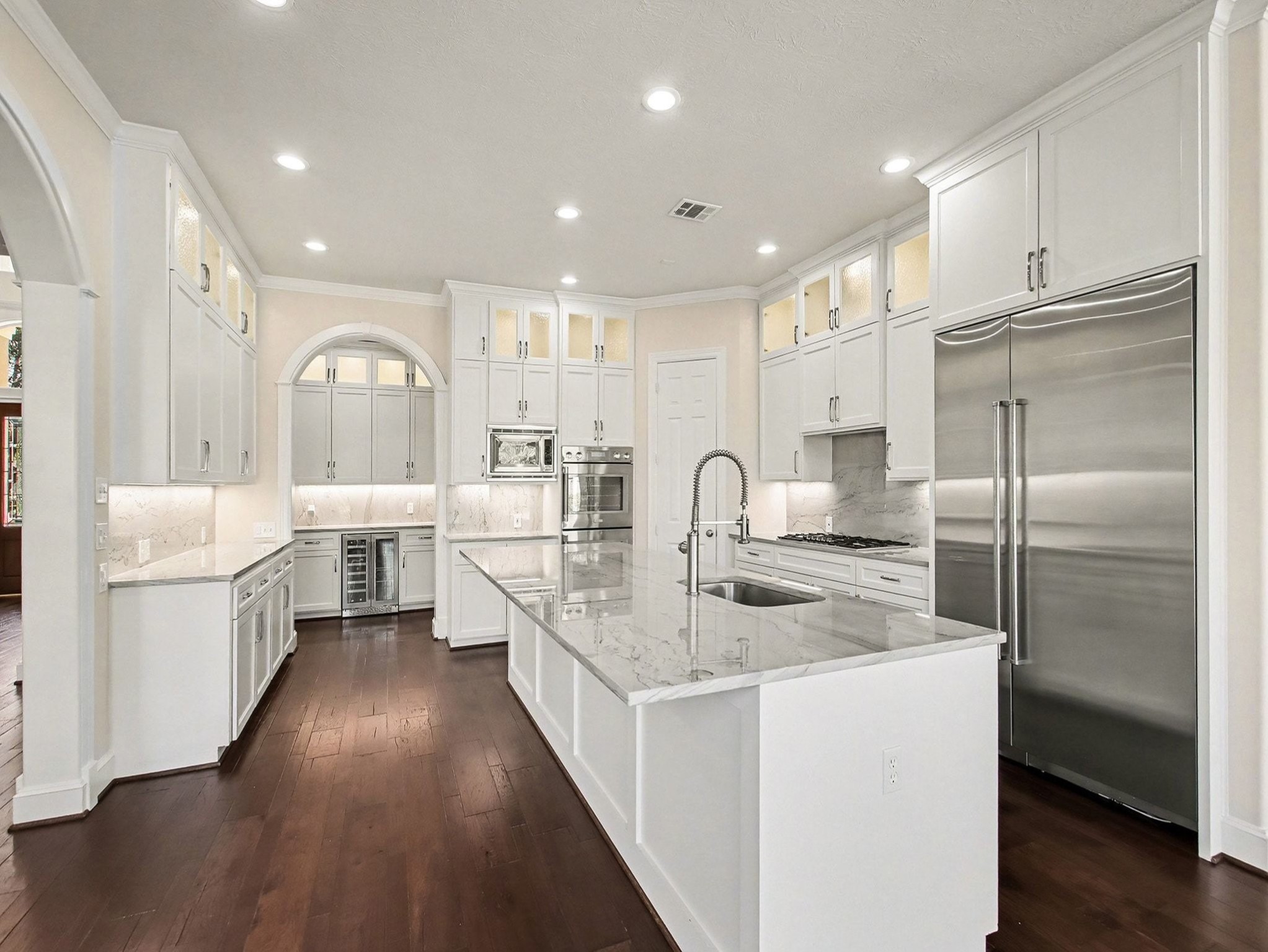 22918 Chaus Court Katy, TX 77494 - Photo 15 of 35 a large kitchen with stainless steel appliances a large counter top a stove a sink and a refrigerator