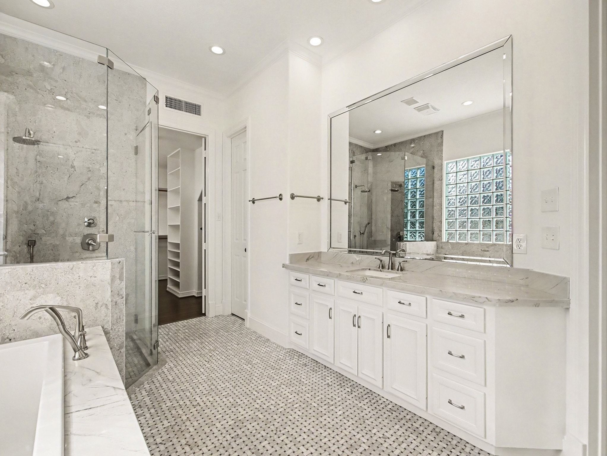 22918 Chaus Court Katy, TX 77494 - Photo 26 of 35 a bathroom with a granite countertop sink a large mirror a shower and bathtub