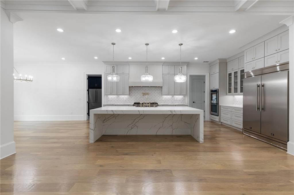 461 Harry McCarty Road Bethlehem, GA 30620 - Photo 14 of 78 a large kitchen with stainless steel appliances kitchen island a large counter top and a refrigerator