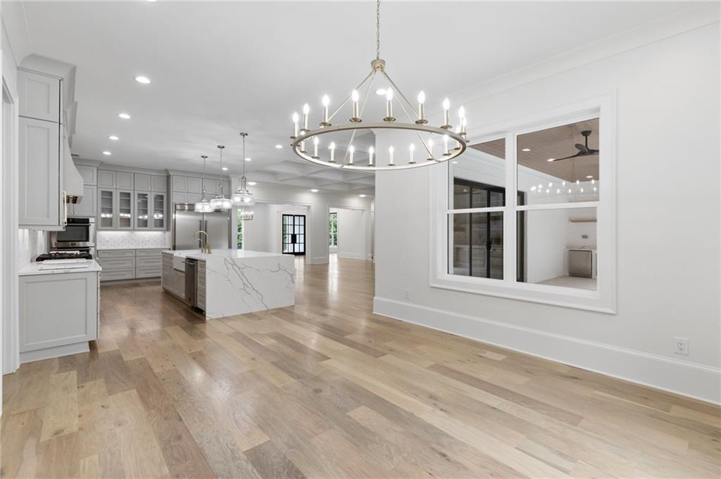 461 Harry McCarty Road Bethlehem, GA 30620 - Photo 22 of 78 a view of a kitchen with kitchen island stainless steel appliances wooden floor dining table and chairs