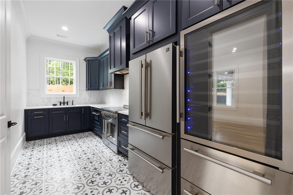 461 Harry McCarty Road Bethlehem, GA 30620 - Photo 24 of 78 a kitchen with granite countertop a refrigerator and a sink