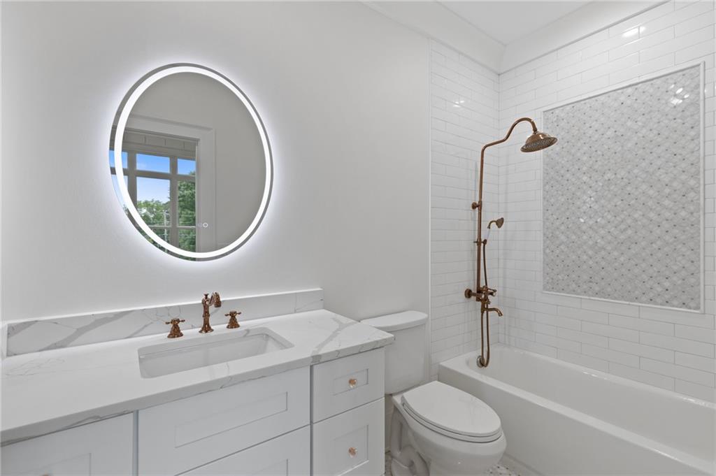 461 Harry McCarty Road Bethlehem, GA 30620 - Photo 49 of 78 a bathroom with a toilet a sink a mirror and a bathtub