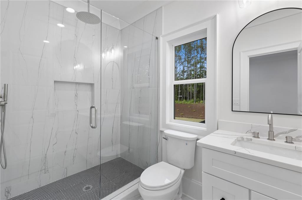 461 Harry McCarty Road Bethlehem, GA 30620 - Photo 54 of 78 a bathroom with a sink a toilet and shower