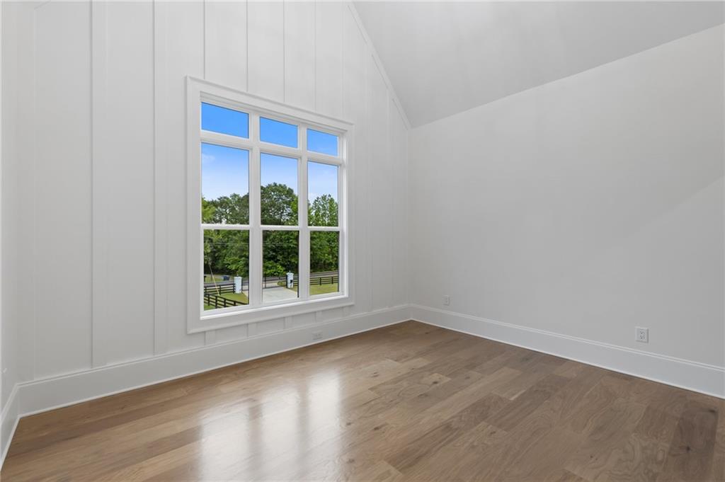 461 Harry McCarty Road Bethlehem, GA 30620 - Photo 55 of 78 an empty room with wooden floor and a window