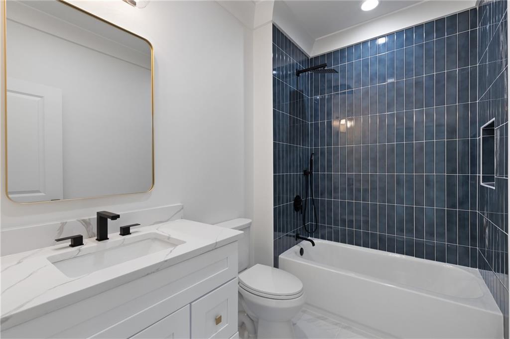 461 Harry McCarty Road Bethlehem, GA 30620 - Photo 57 of 78 a bathroom with a bathtub shower sink vanity mirror and toilet