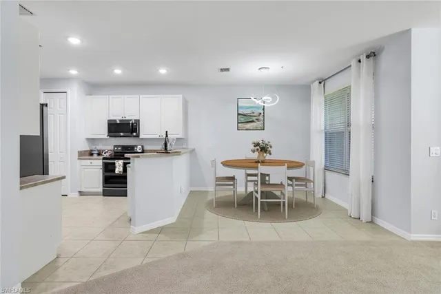 a kitchen with a table and chairs in it