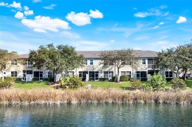 a view of a lake with a house swimming pool and outdoor space