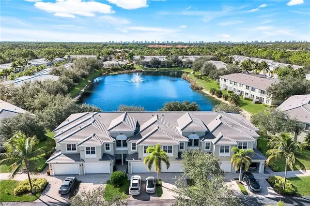 an aerial view of residential houses with outdoor space and ocean view