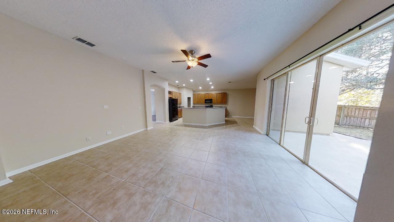 14454 Millhopper Road Jacksonville, FL 32258 - Photo 6 of 44 a view of an empty room with a window