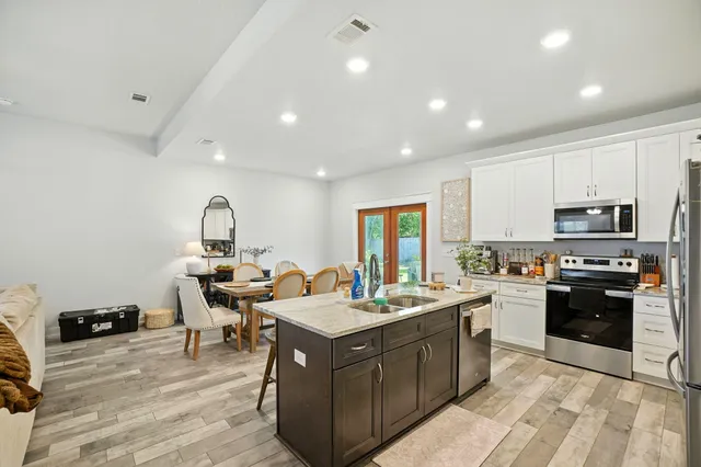 a kitchen with a sink appliances and cabinets