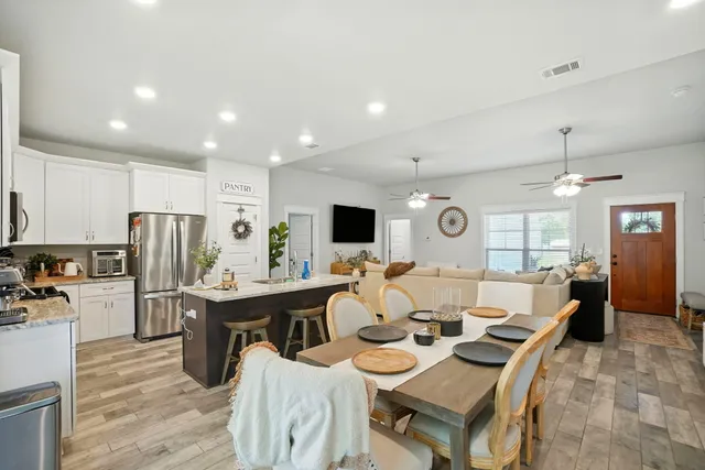 a large kitchen with a table and chairs