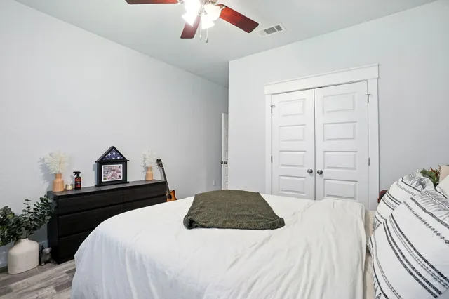 a bedroom with a bed and a chandelier