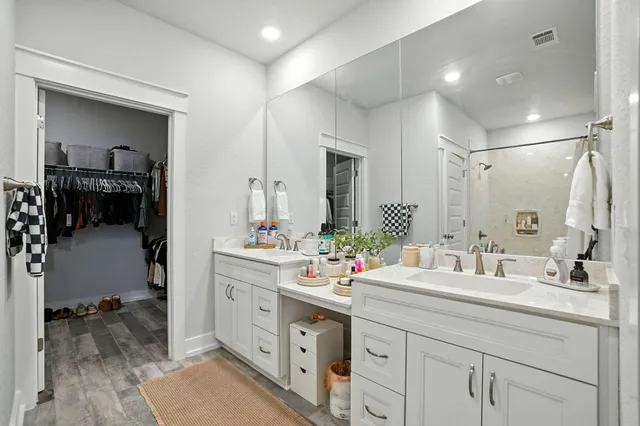 a bathroom with a double vanity sink mirror and double