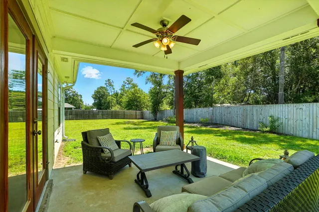 a view of swimming pool with a couches chairs and a table