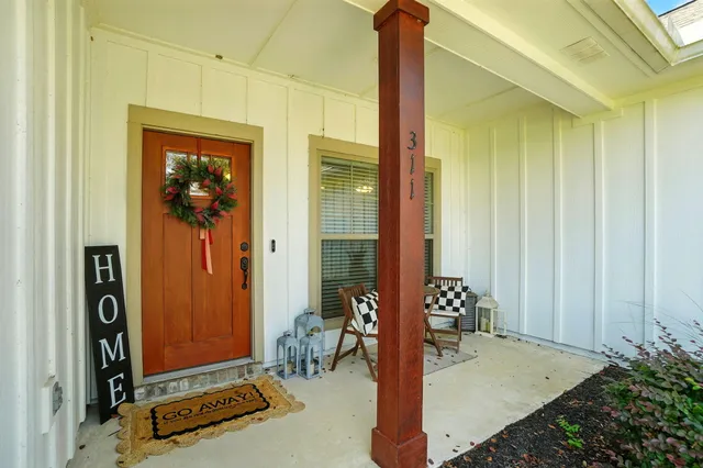 a front view of a house with a potted plant
