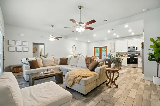 a living room with couches and kitchen view