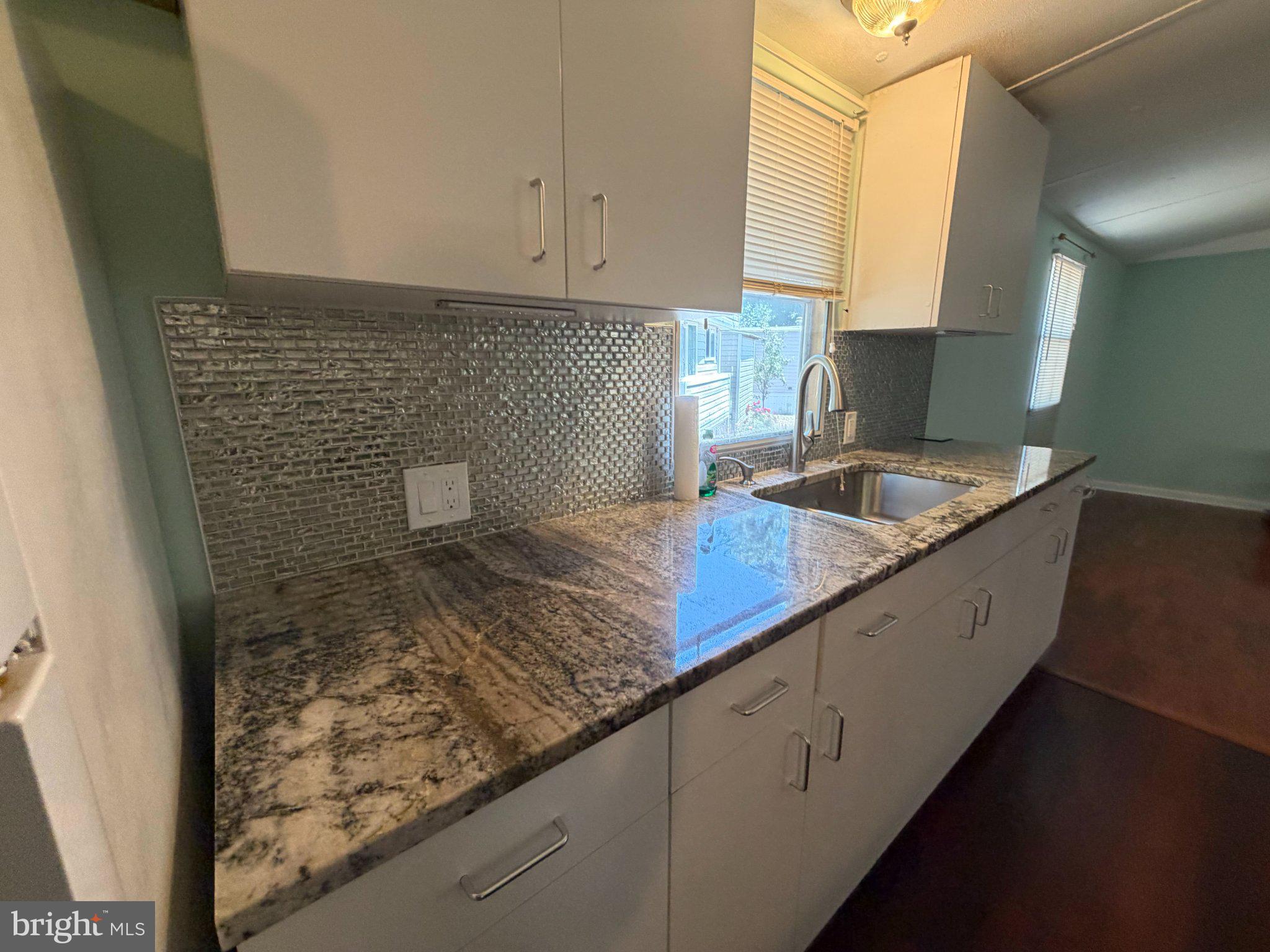 7923 Stork Road Alexandria, VA 22306 - Photo 12 of 17 Sleek kitchen with modern finishes.