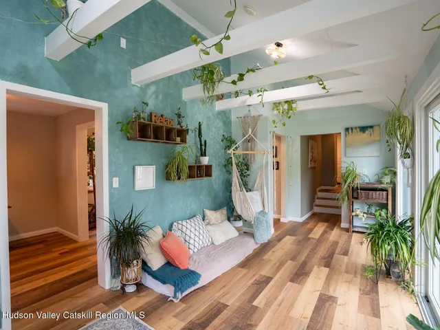 a living room with furniture and a potted plant