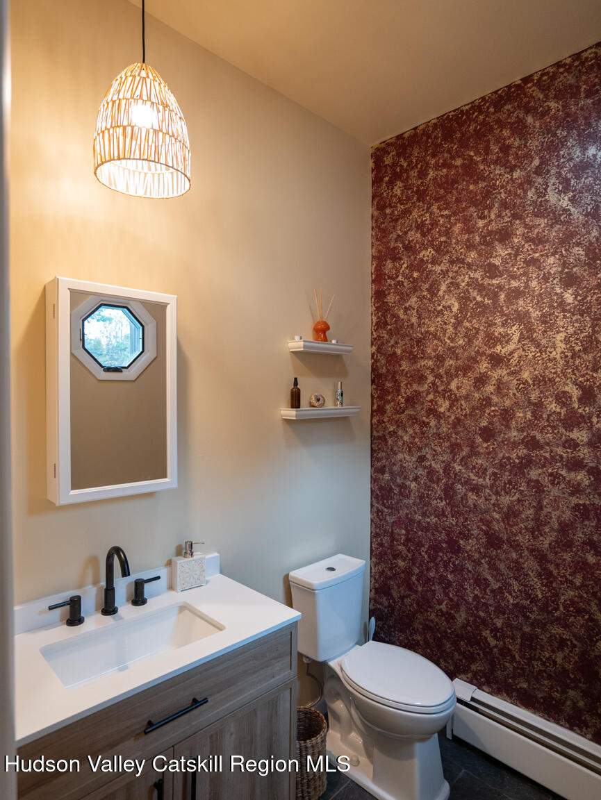 8 Creekside Road Hopewell Junction, NY 12533 - Photo 16 of 34 a bathroom with a toilet a sink and a mirror