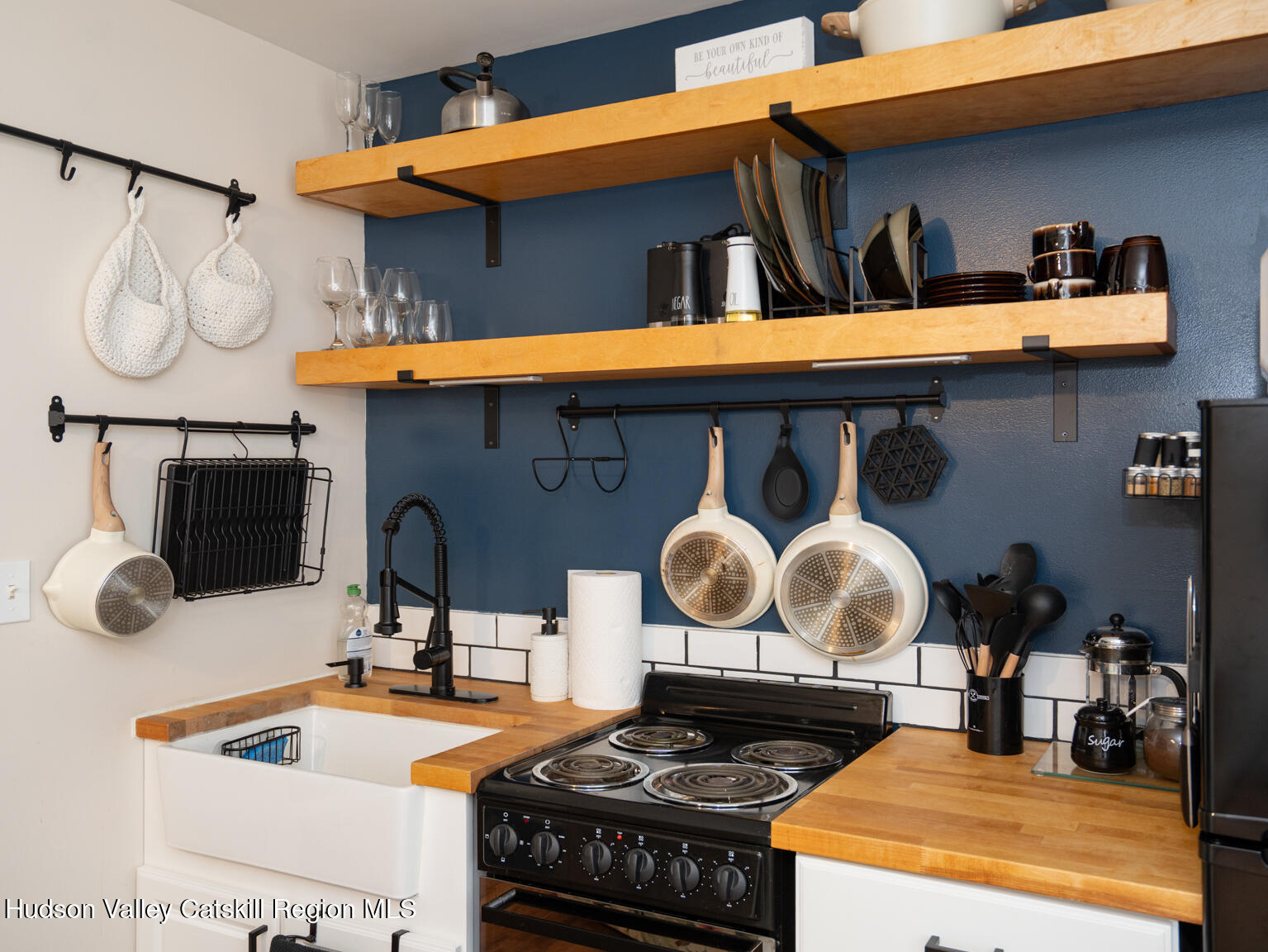 8 Creekside Road Hopewell Junction, NY 12533 - Photo 27 of 34 a kitchen with a stove a sink and a wooden cabinets