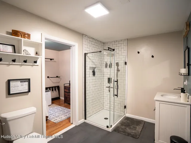 a bathroom with a shower toilet and sink