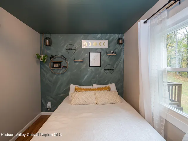 a bedroom with a bed and a book shelf