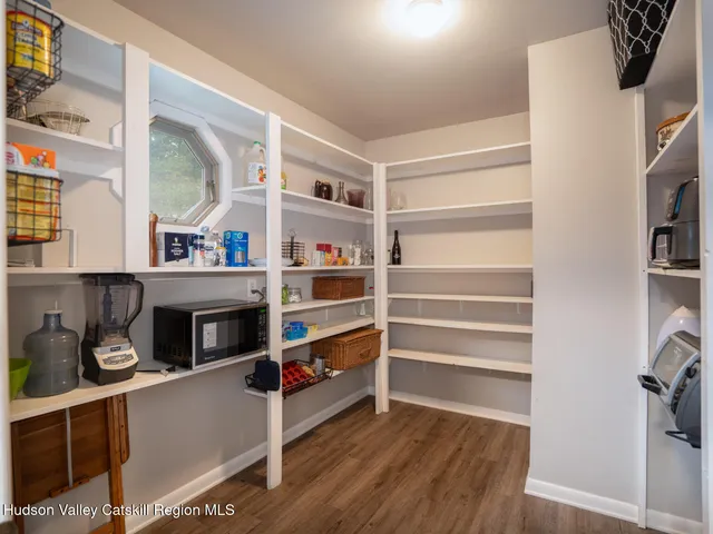 a room with storage and a fireplace