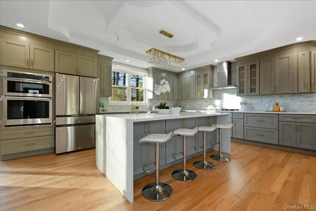 a kitchen with stainless steel appliances granite countertop a sink refrigerator and cabinets