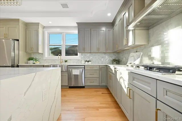 a kitchen with appliances a sink and cabinets