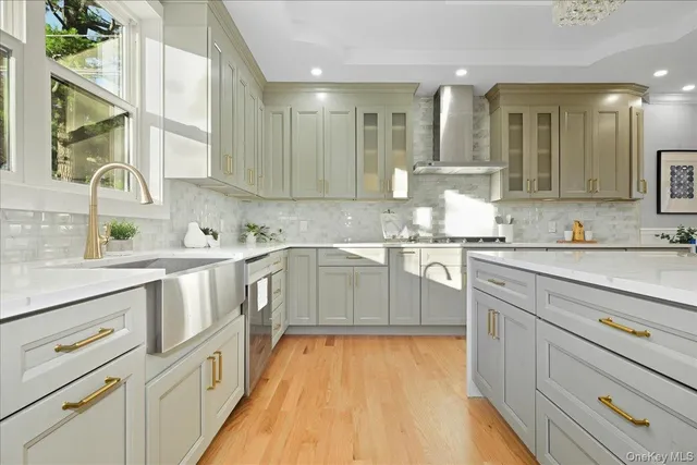a large white kitchen with lots of counter space and furniture