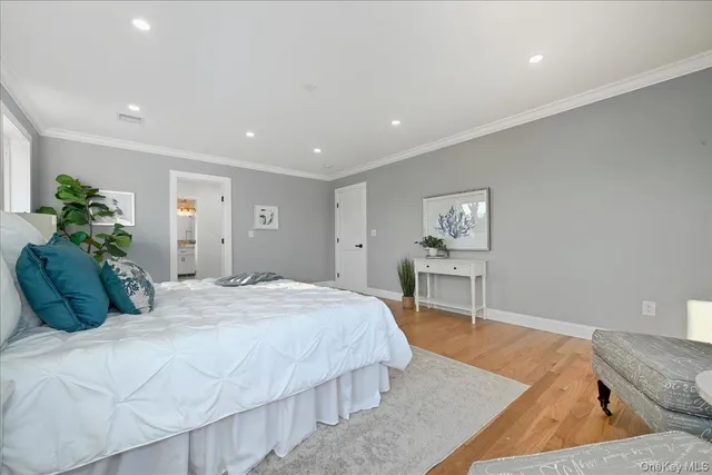 a living room with a bed furniture and next to a window