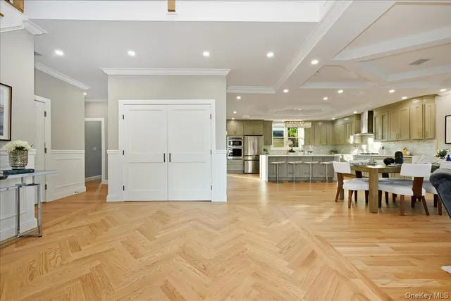 a view of kitchen with kitchen island granite countertop lots of counter top space and stainless steel appliances