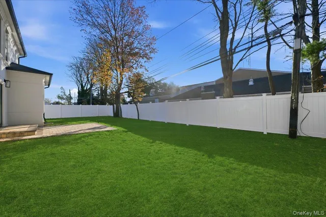 a view of yard with grass and a large tree