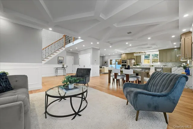 a living room with furniture kitchen view and a table