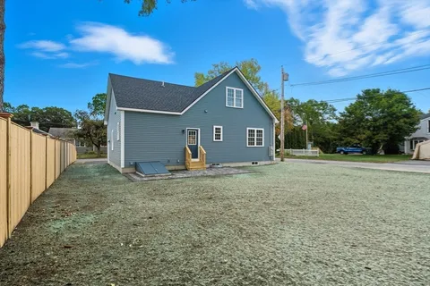 a view of a backyard with a tree