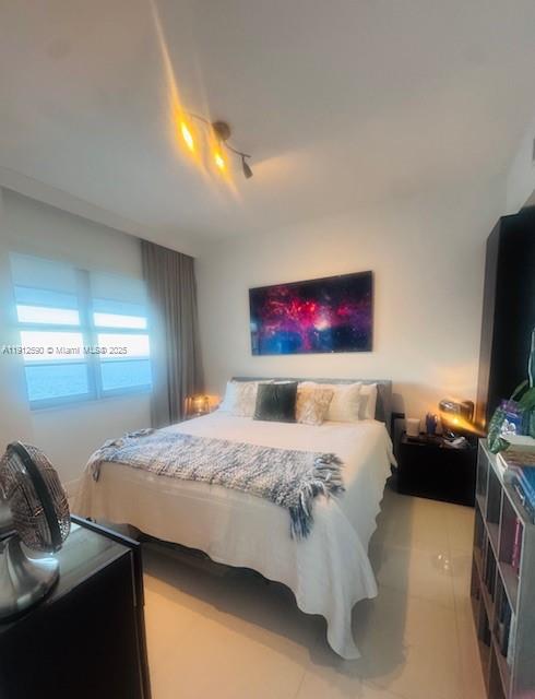 5701 Collins Avenue, Unit PH10 Miami Beach, FL 33140 - Photo 6 of 24 a bedroom with a bed and a flat screen tv