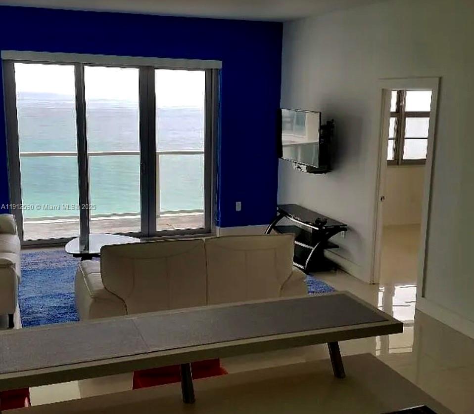 5701 Collins Avenue, Unit PH10 Miami Beach, FL 33140 - Photo 7 of 24 a living room with furniture pool table and flat screen tv