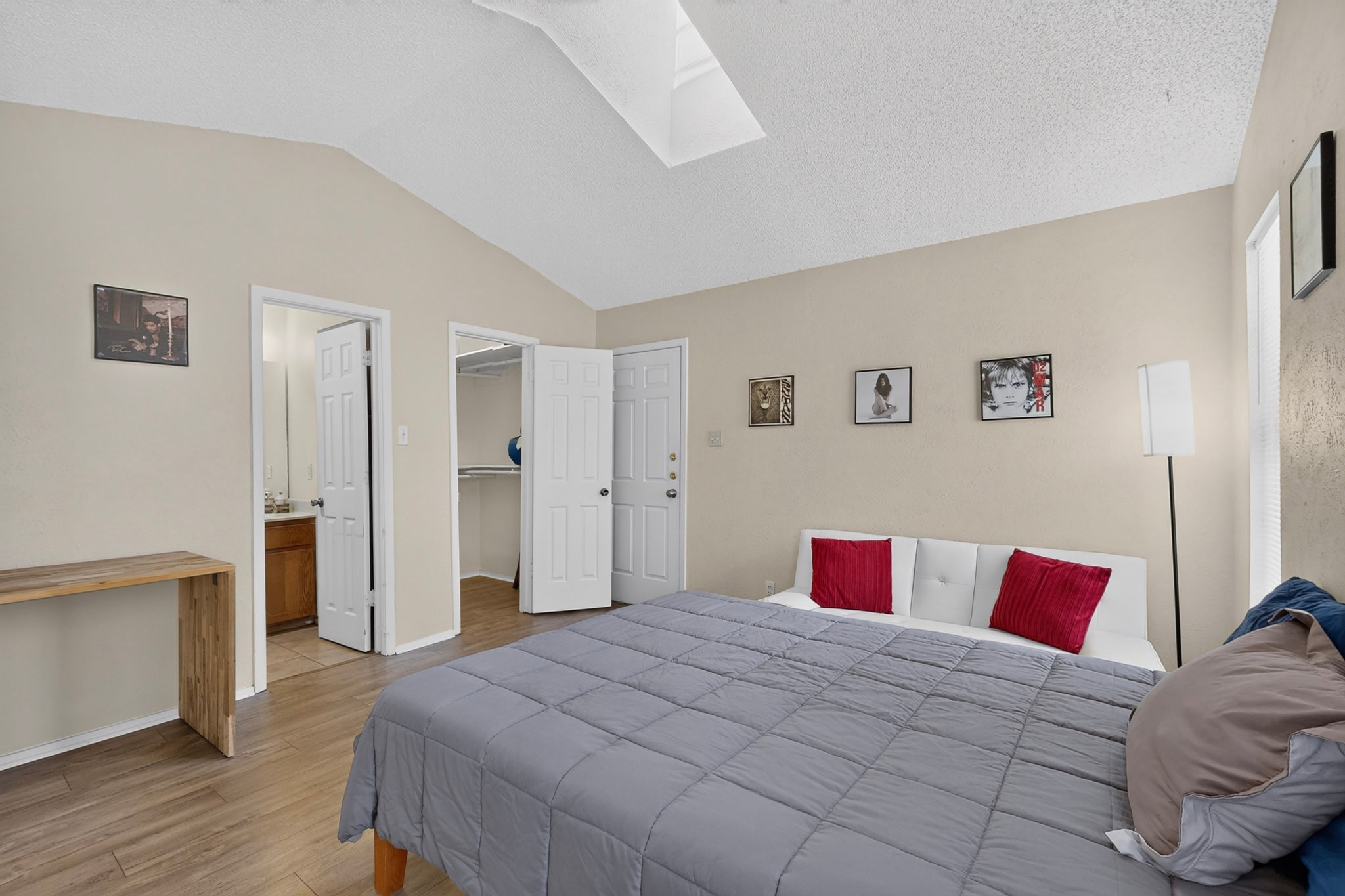 1602 Waterloo Trail, Unit B Austin, TX 78704 - Photo 16 of 31 A spacious bedroom offers vaulted ceilings with a skylight and wood flooring throughout.