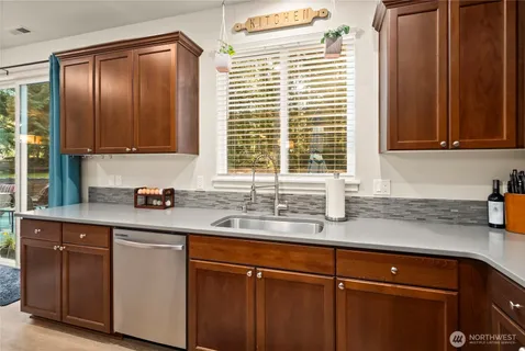 a kitchen with granite countertop cabinets and window