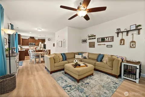 a living room with furniture and kitchen view