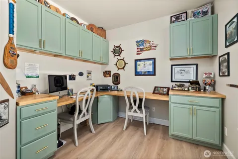 a kitchen with a table chairs and a refrigerator