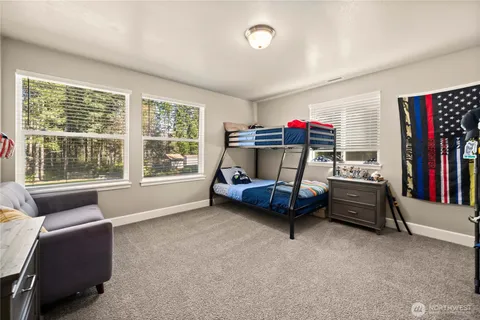 a bedroom with furniture and a large window