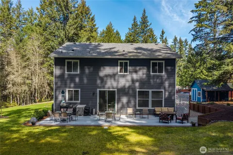 a view of a house with backyard porch and sitting area