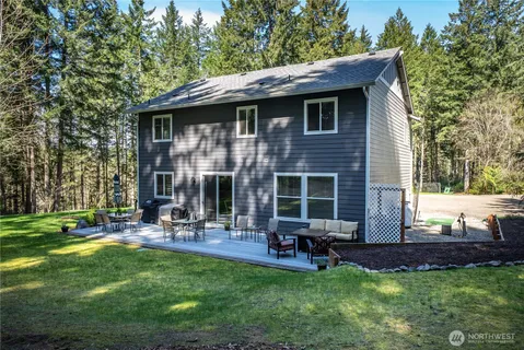 a front view of house with yard and outdoor seating